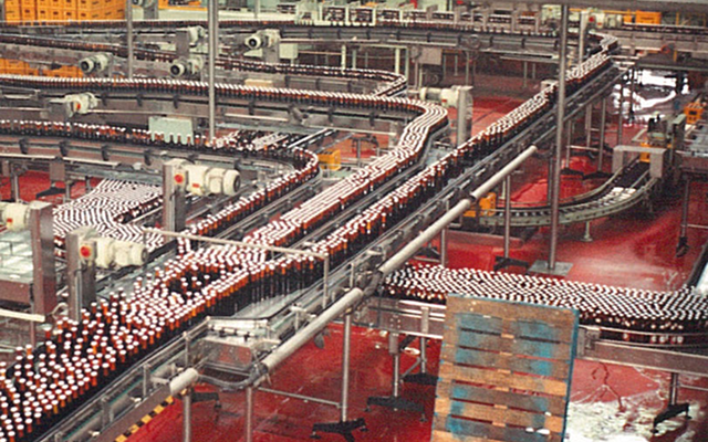 Jupiler bottling line on the production floor, marking the 1988 Interbrew merger and expansion into the Netherlands.